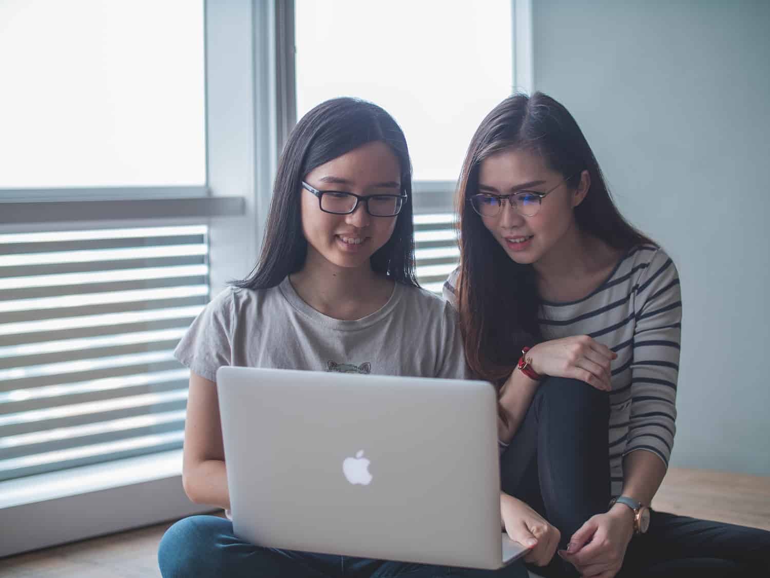 teen girls working on a laptop