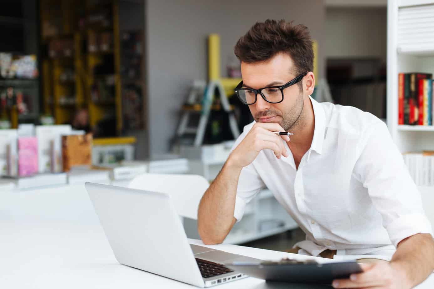 man working on a laptop in a library