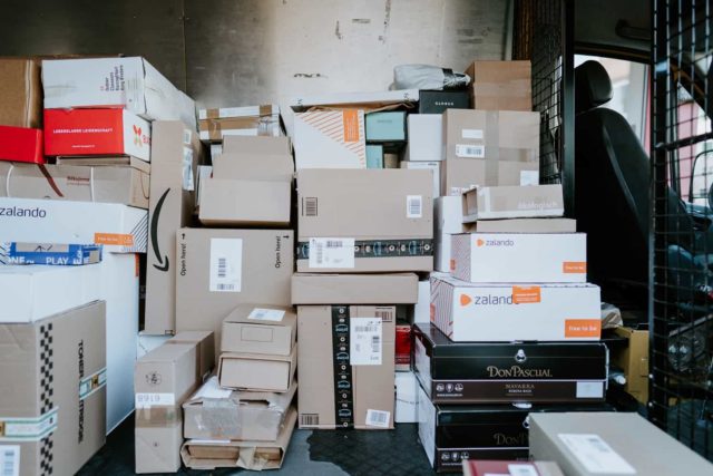 Amazon packages on a mail delivery truck