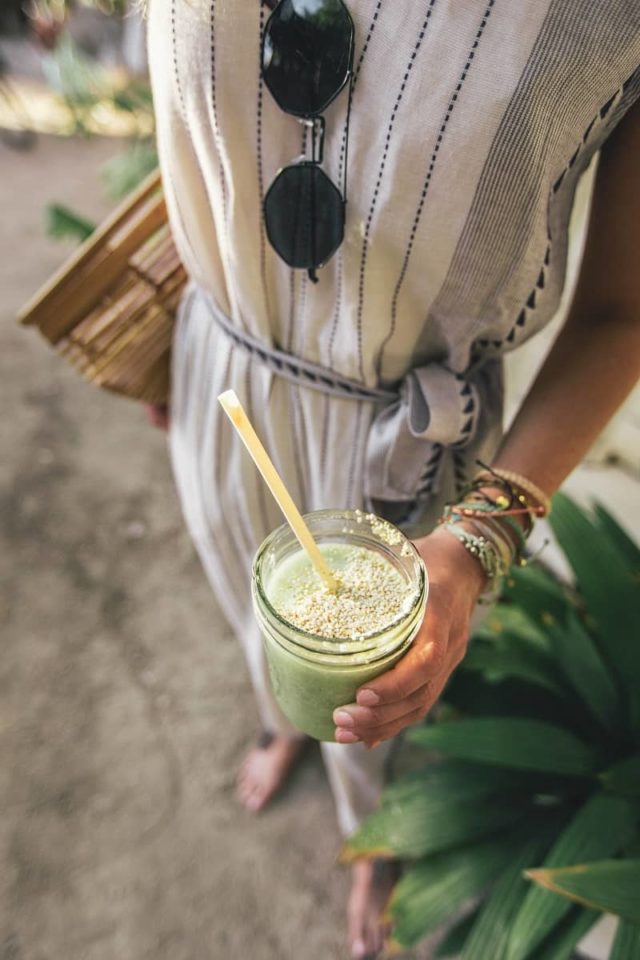 woman holding healthy green drink