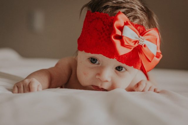 baby wearing red headband
