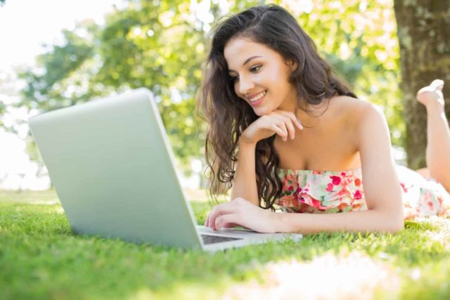 woman proofreading on a laptop