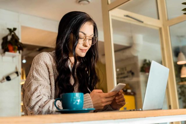 woman using smartphone to sign up and get money instantly