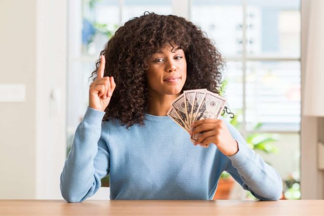 woman holding $50 dollar bills