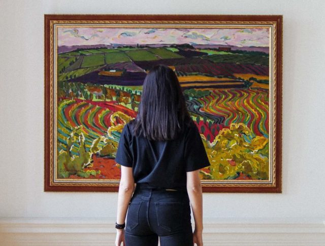 woman looking at fine art piece