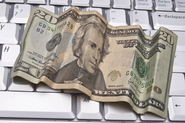 20 dollar bill on a laptop keyboard