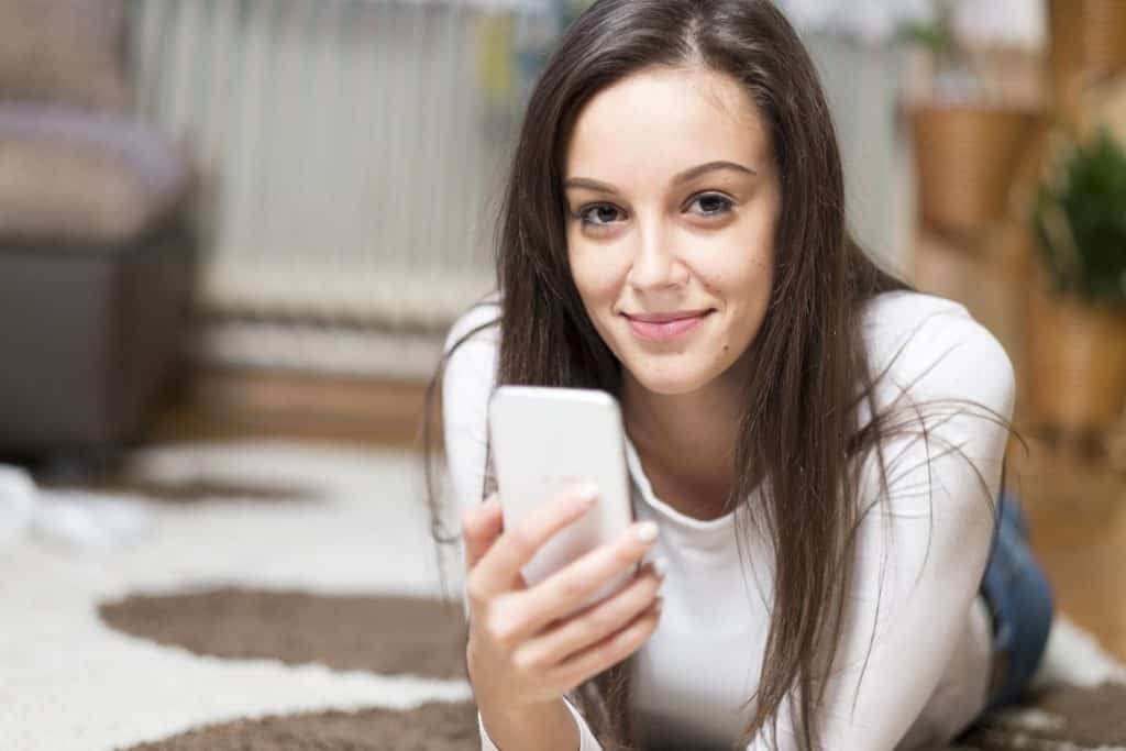 young woman holding smartphone