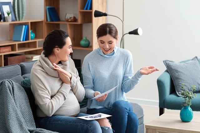 Doula explaining birthing process to a pregnant woman