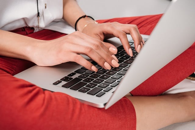 Woman copyediting on a laptop