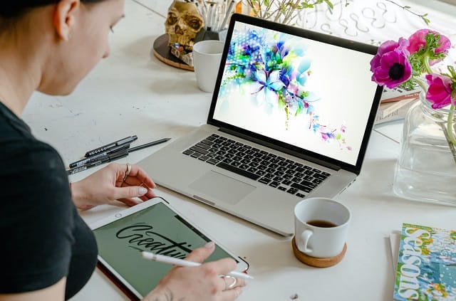 woman designing graphics on a laptop