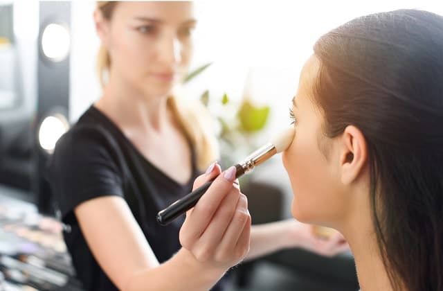 Makeup artist doing woman's makeup