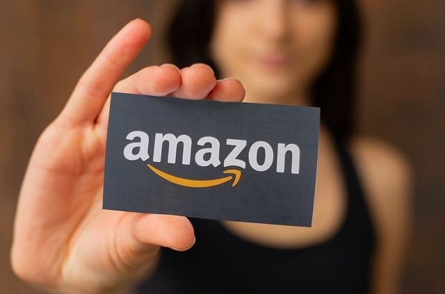 Woman holding free Amazon gift card