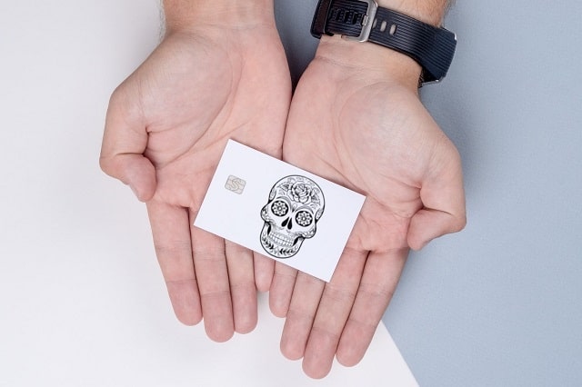 Cash Card designed with skeleton displayed in hands