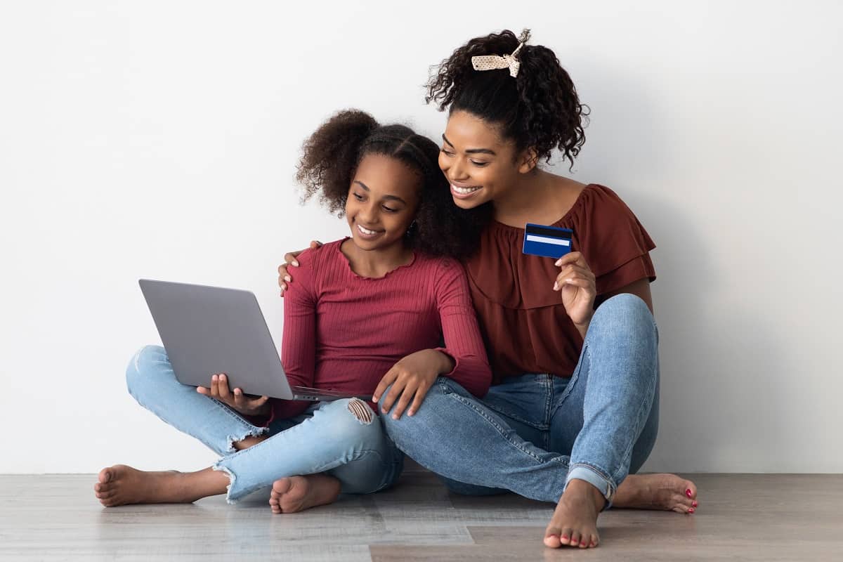 Mother and daughter shopping online with Greenlight debit card