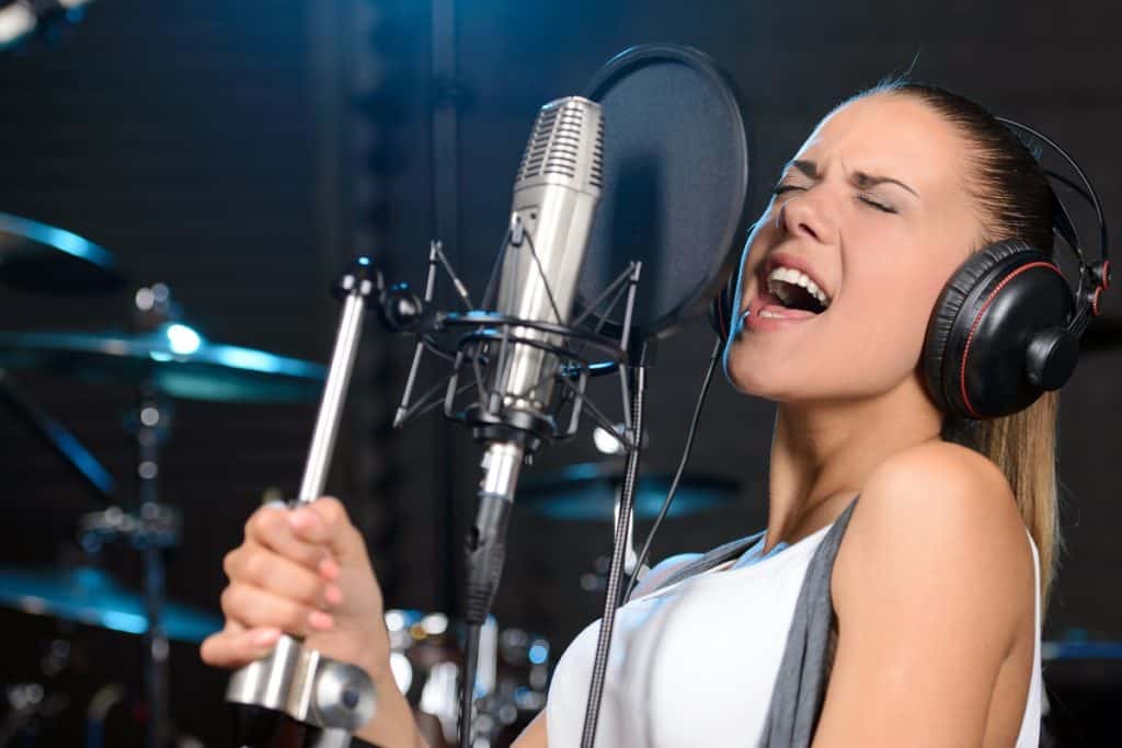 Woman getting paid to sing in a recording studio