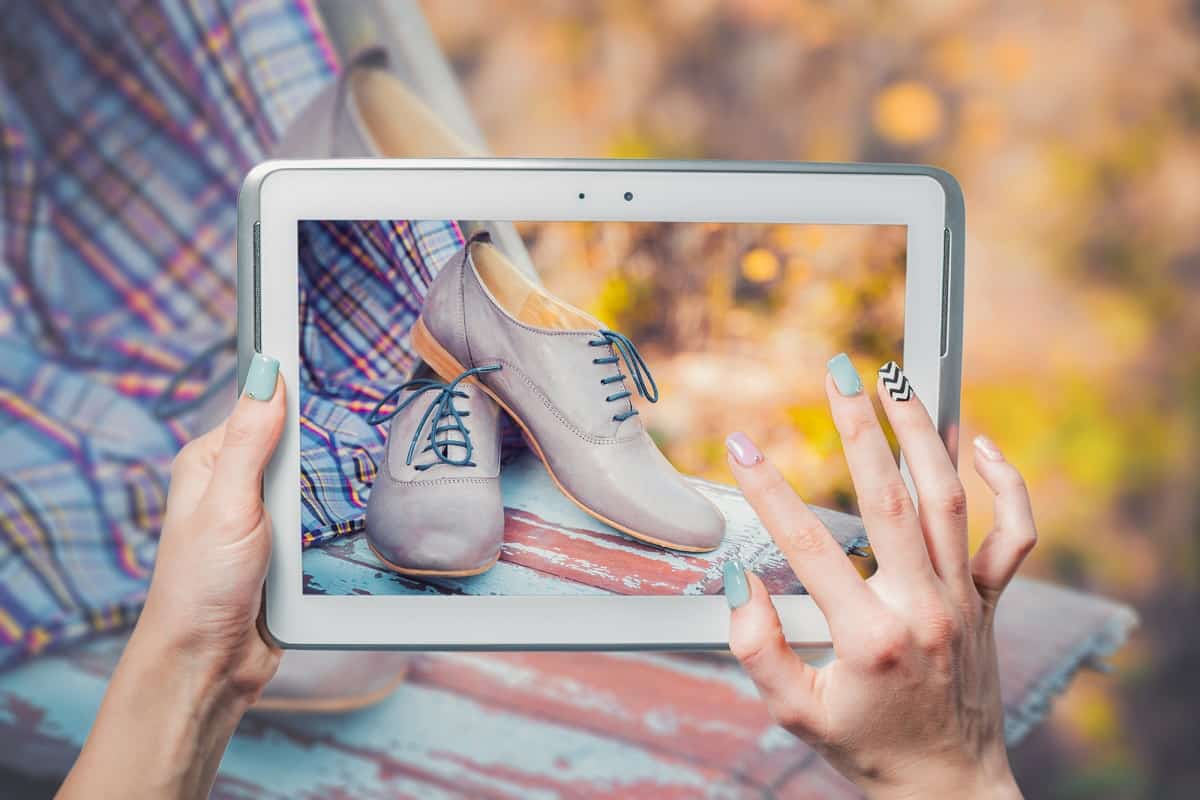 Woman taking picture of shoes to list and sell