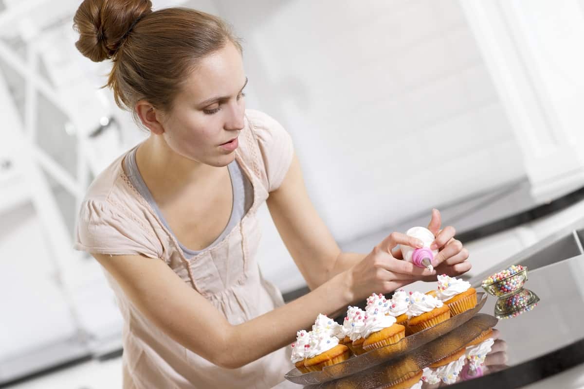 Woman decorating cupcakes she baked