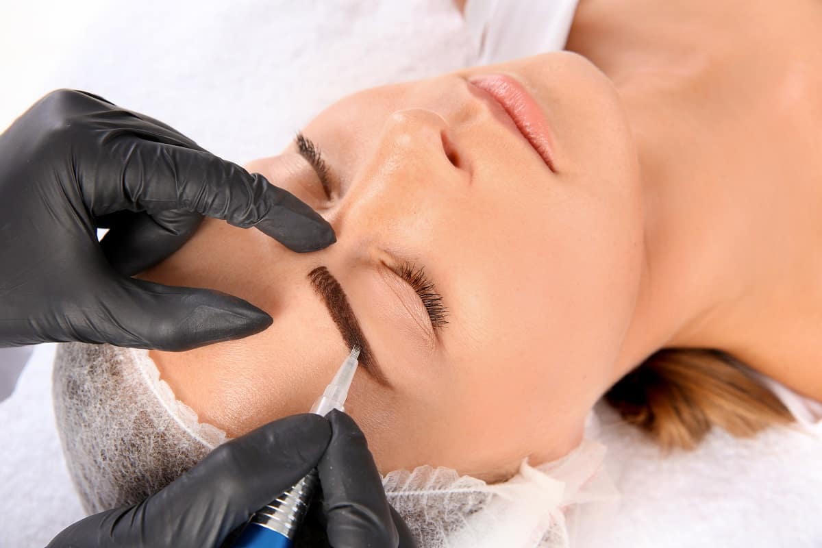 Woman getting eyebrows microbladed