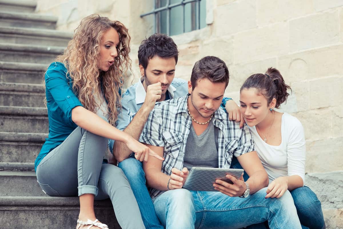 Group of friends looking at a tablet