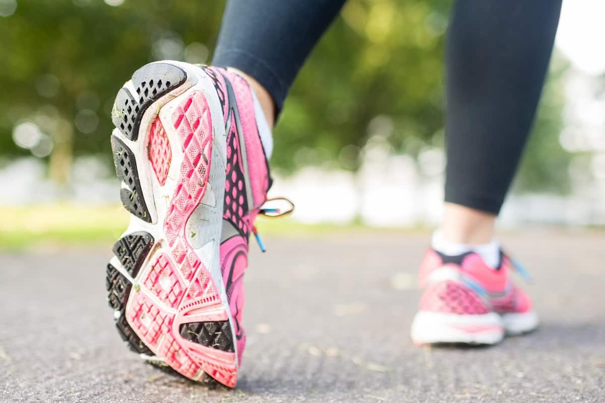 Person walking in pink sneakers