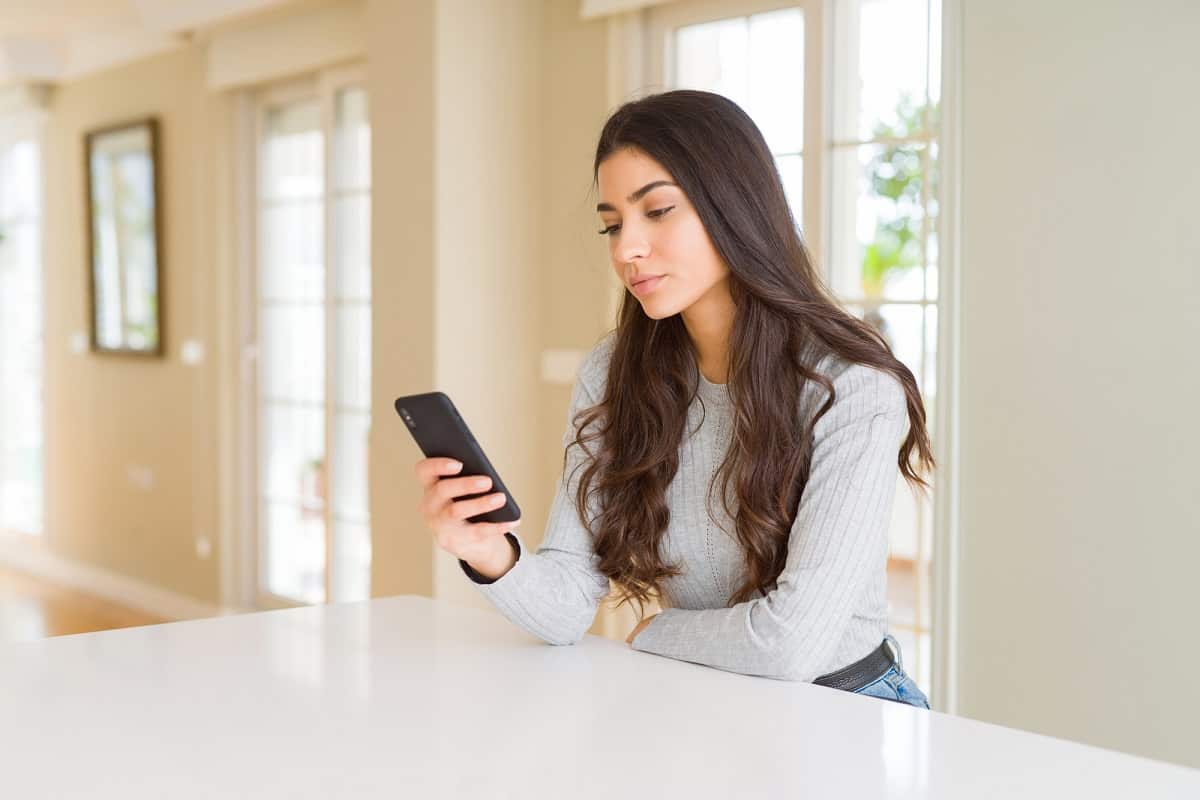 Woman getting paid to download apps on a smartphone