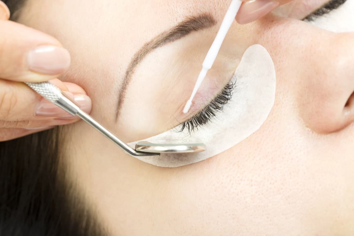 Woman getting eyelash extensions