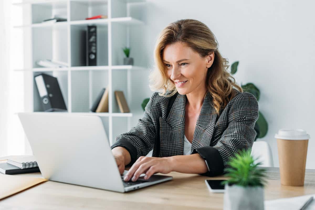 Woman smiling working on laptop