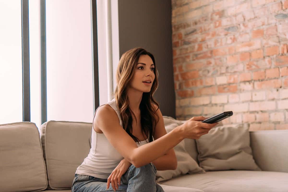 Woman holding TV remote