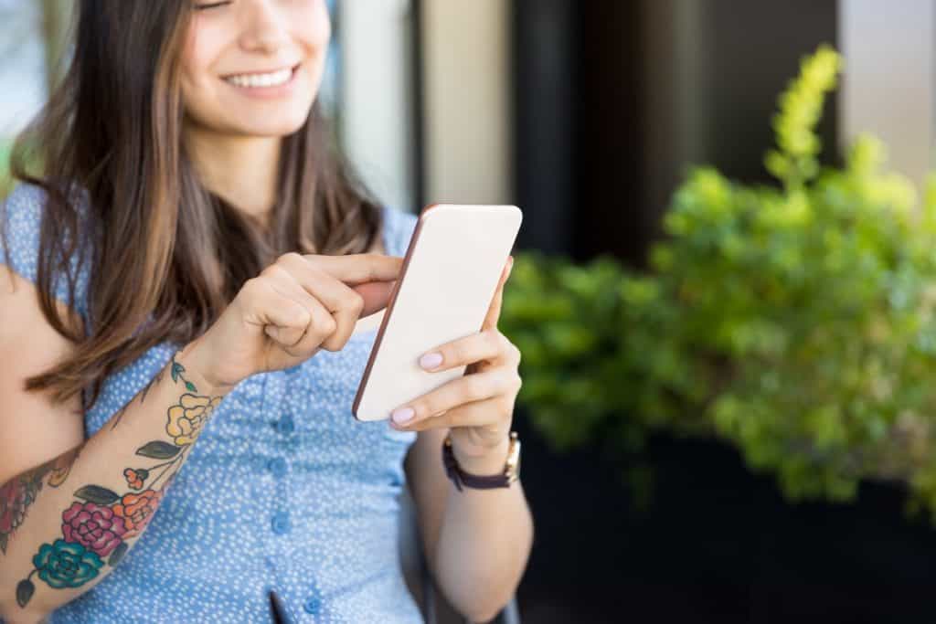 Woman scrolling Instragram on a smartphone