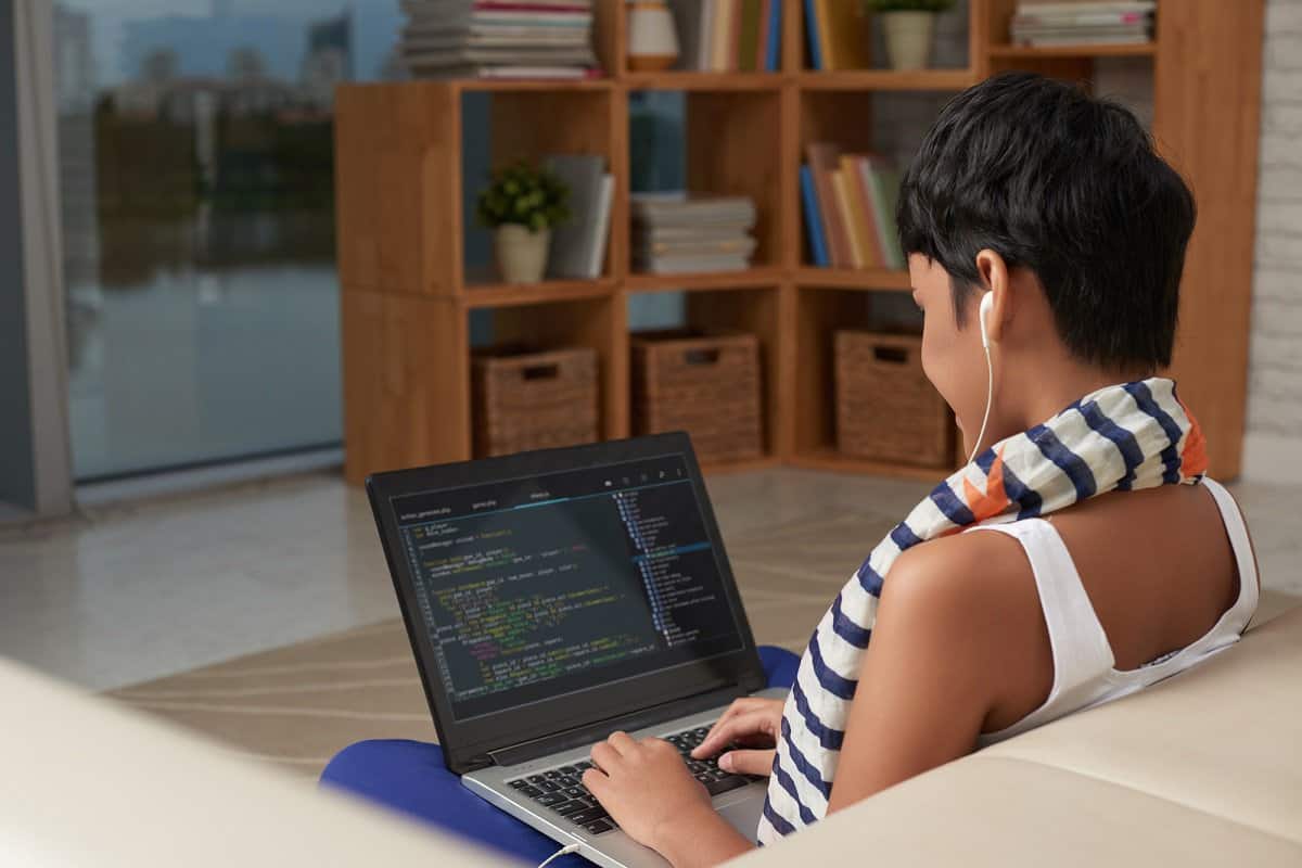 Woman getting paid to code on a laptop