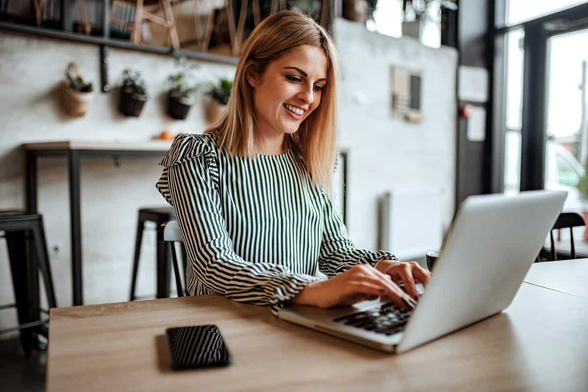 Woman researching short certification programs on a laptop