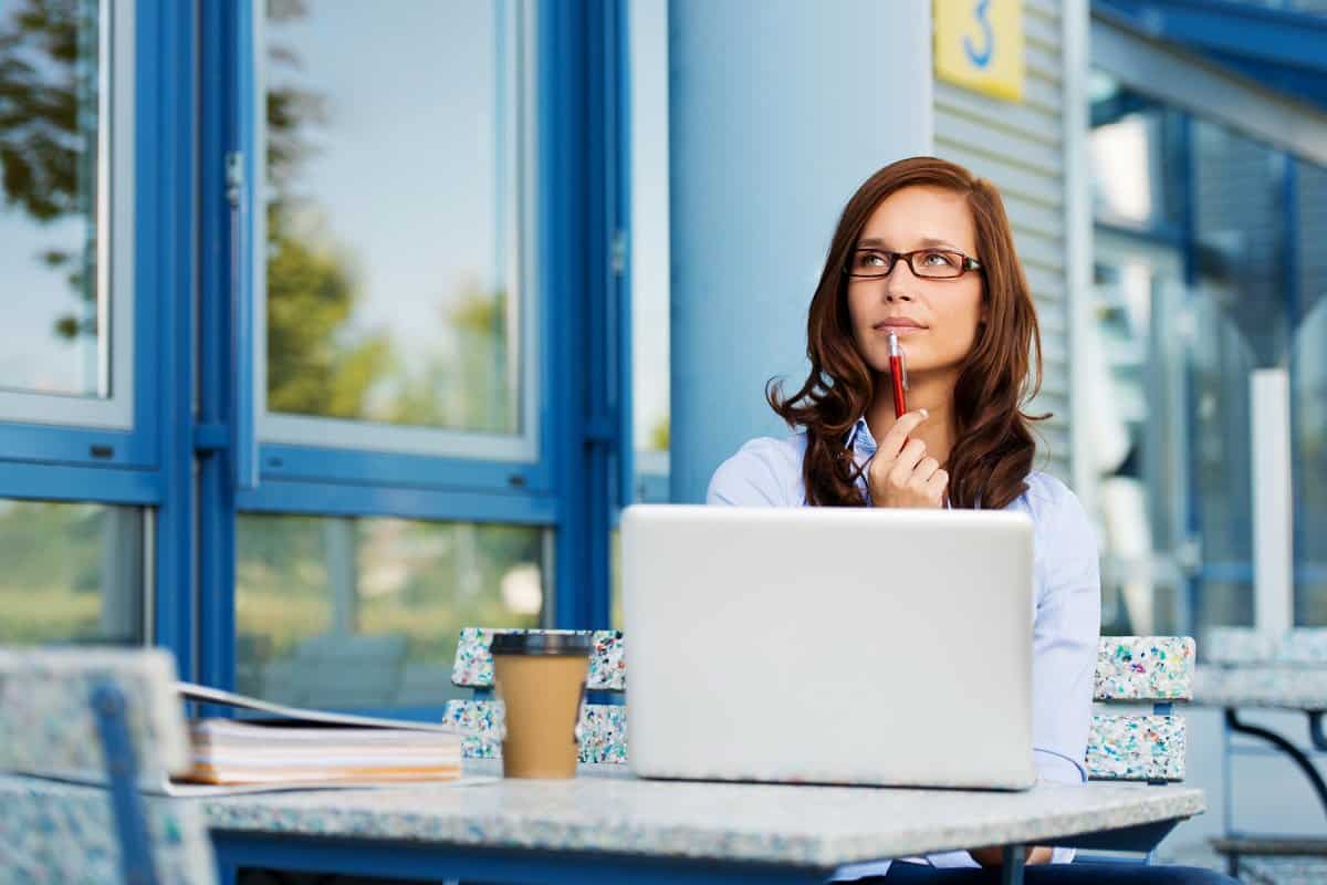 Woman sitting in front of laptop getting paid to think