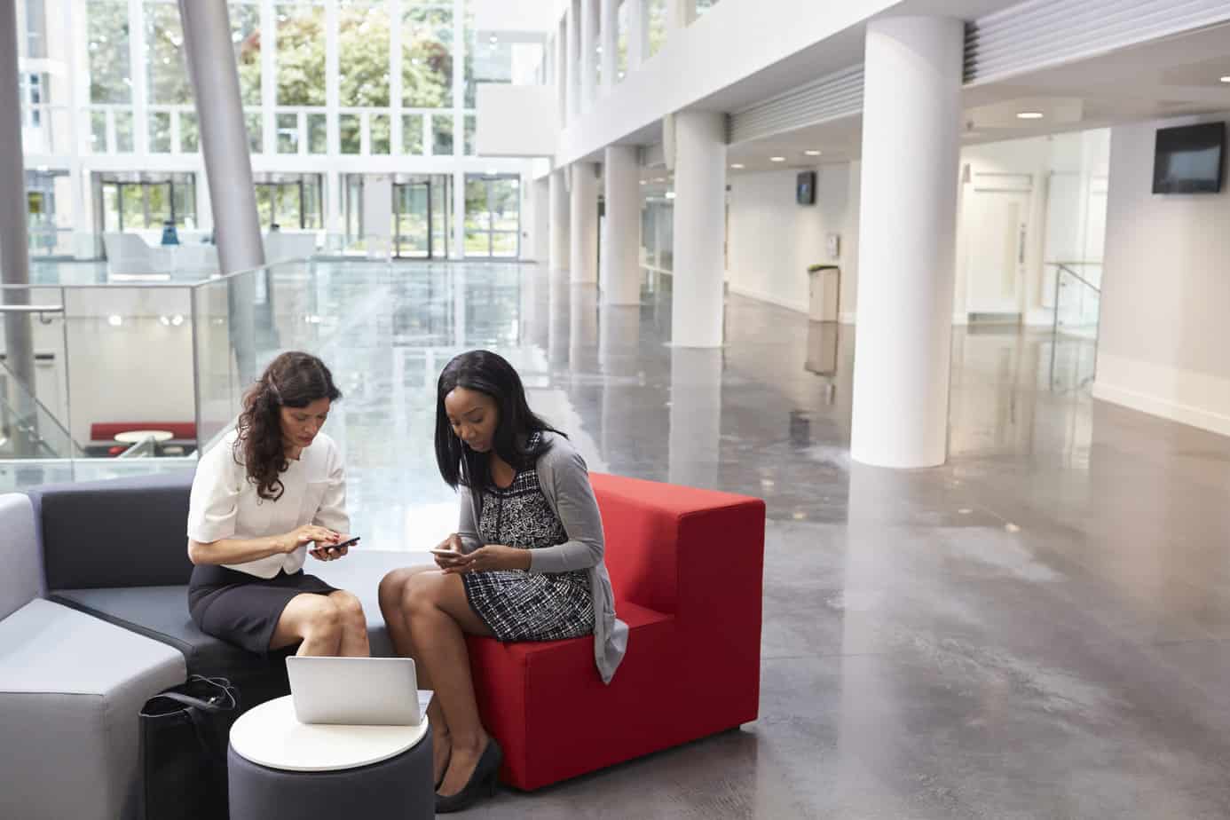 Business women looking at their smartphones