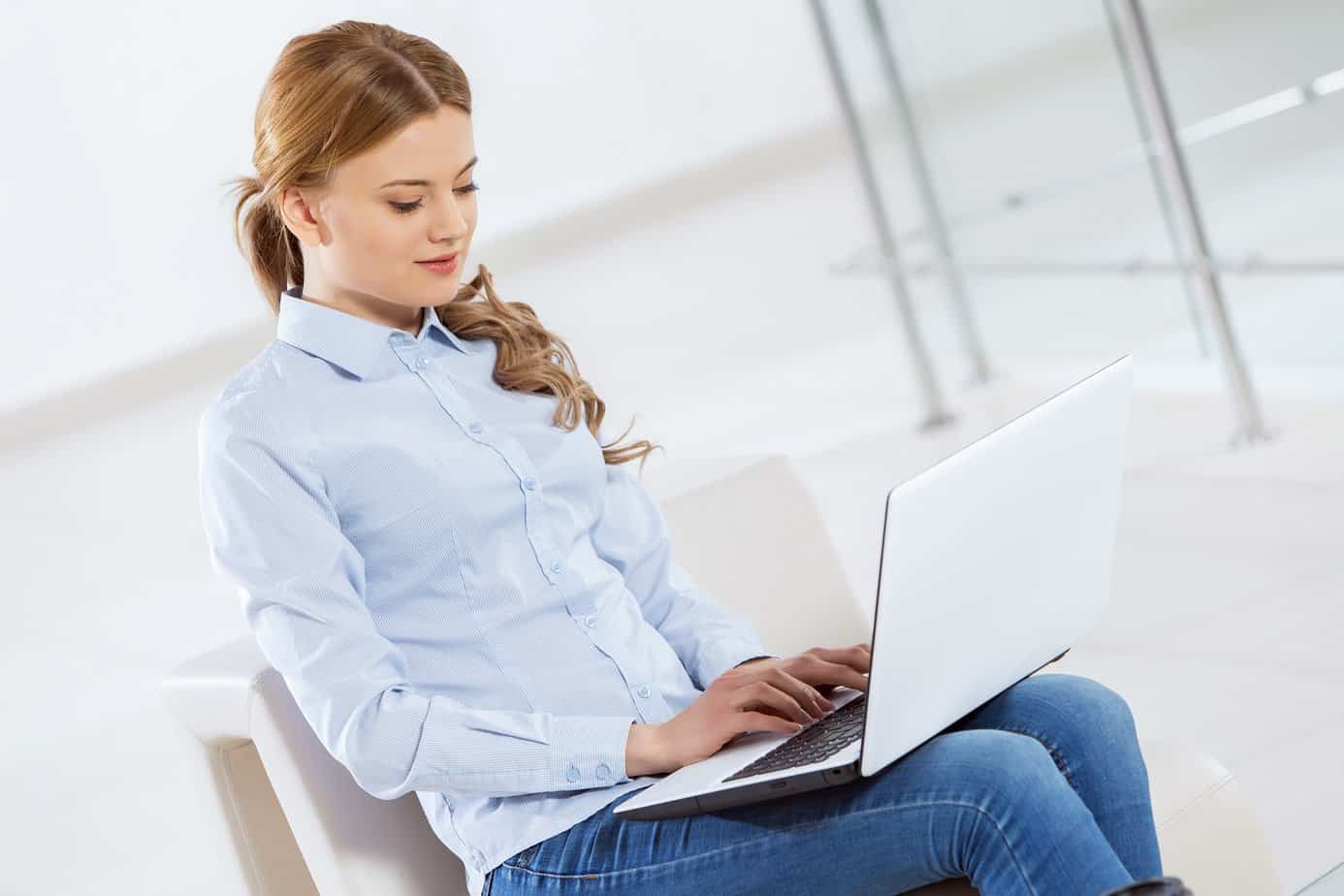 woman smiling working on a laptop