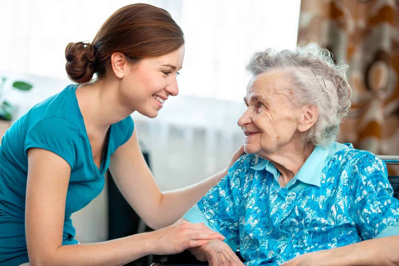 young woman smiling at an elderly woman