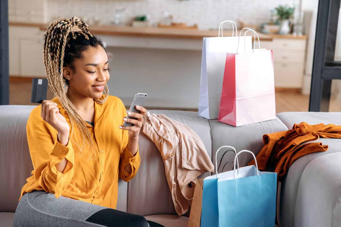 Woman shopping on smartphone holding SHEIN gift card