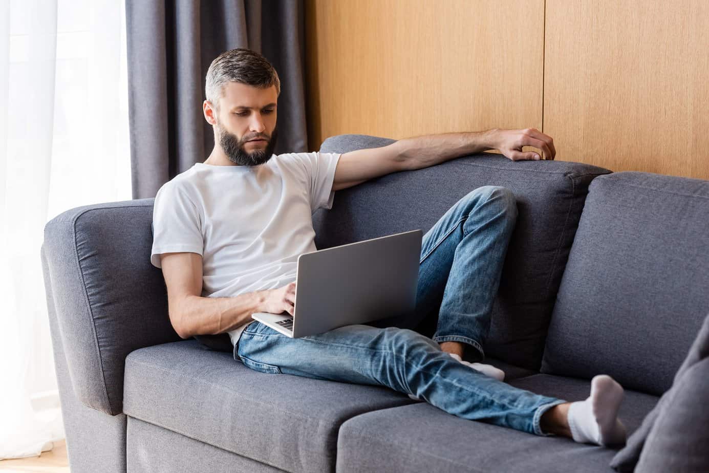 man working a lazy job on a couch