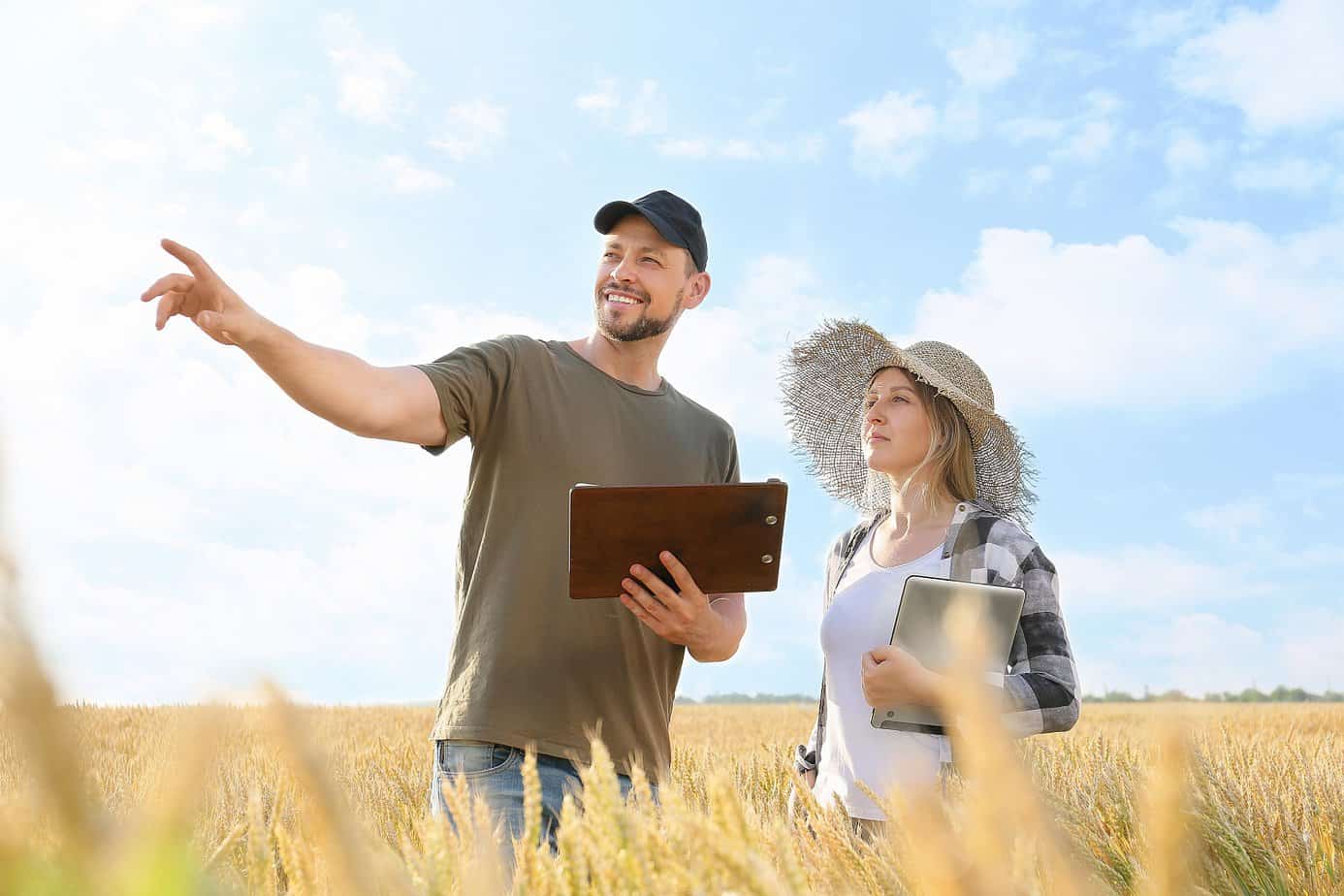 man and woman looking at land to buy and flip