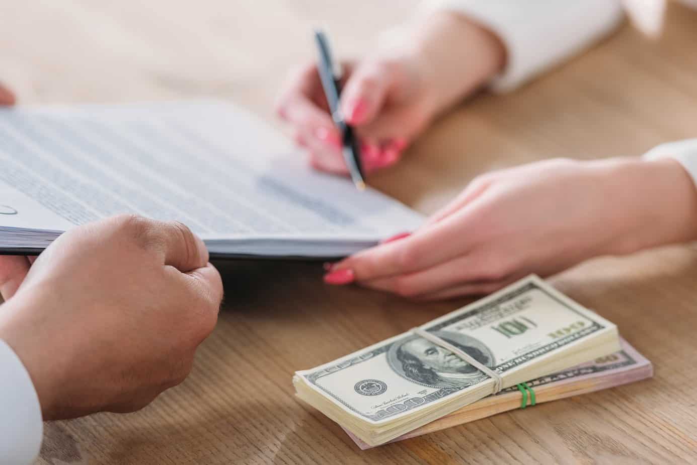 woman signing for rent money loan