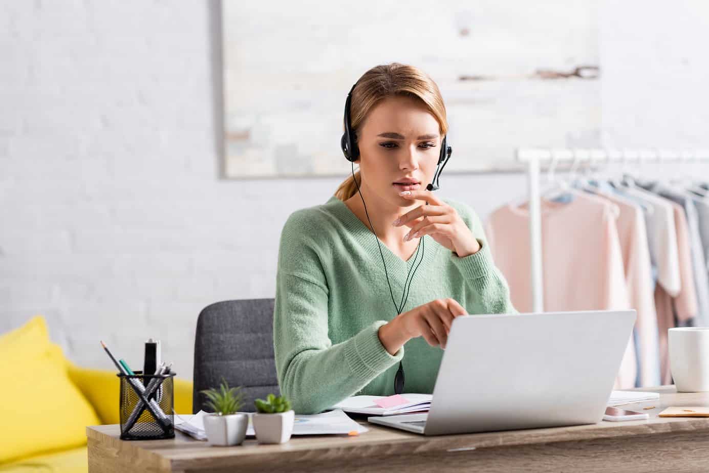 woman talking into microphone in front of laptop