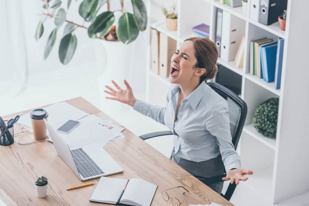 woman yelling in front of work desk