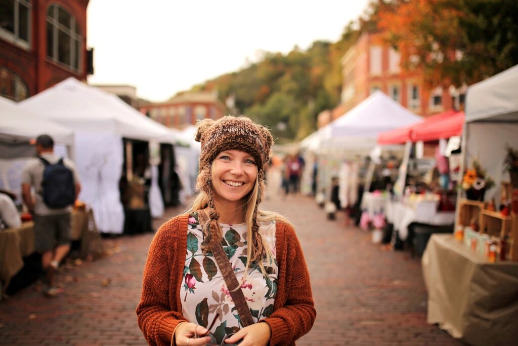 woman smiling at a fall vendor festival