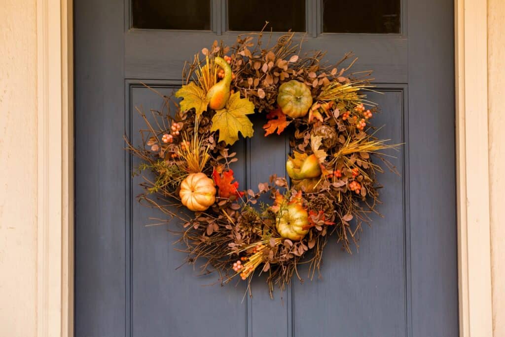 Fall wreath hanging on a black front door